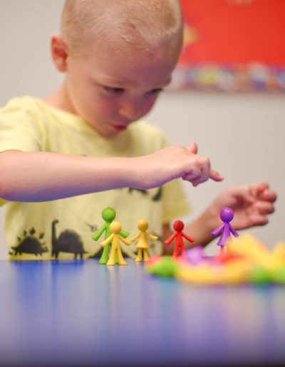 Boy playing with figures at Spring Hill Academy Preschool