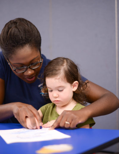 Teacher working with a child at Spring Hill Academy Preschool